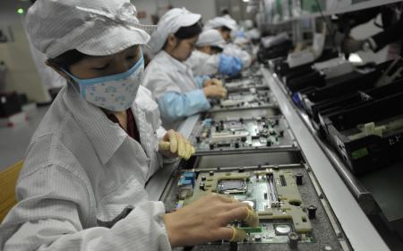 Cette photo d'archive prise le 27 mai 2010 montre des ouvriers chinois dans l'usine Foxconn à